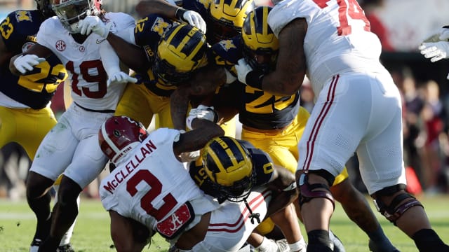 Michigan Wolverines defensive back Mike Sainristil (0) tackles Alabama Crimson Tide running back Jase McClellan (2) in the second quarter in the 2024 Rose Bowl college football playoff semifinal game at Rose Bowl.